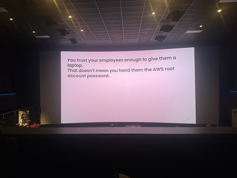 Slide: Quote asserting that trusting employees with a laptop does not mean handing them the AWS root account password